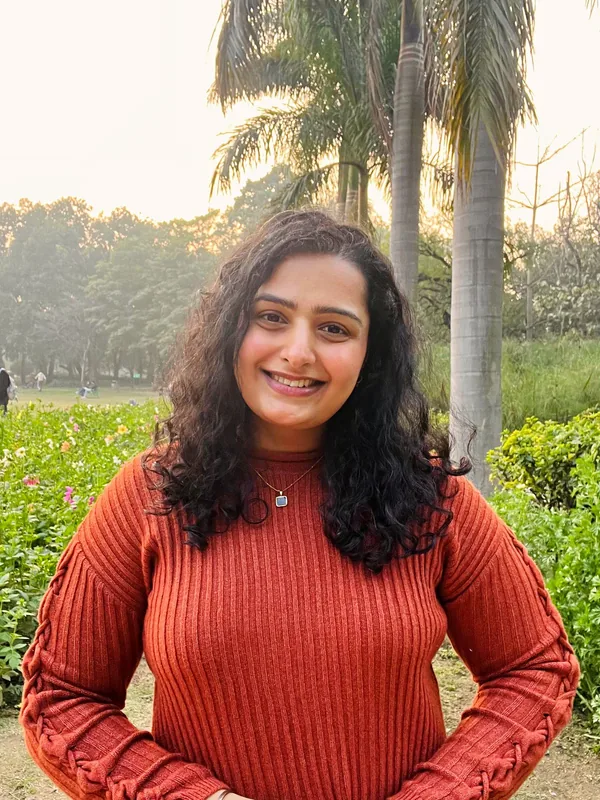 Prachi Saini, founder of Quiet Body Healing, standing in a garden