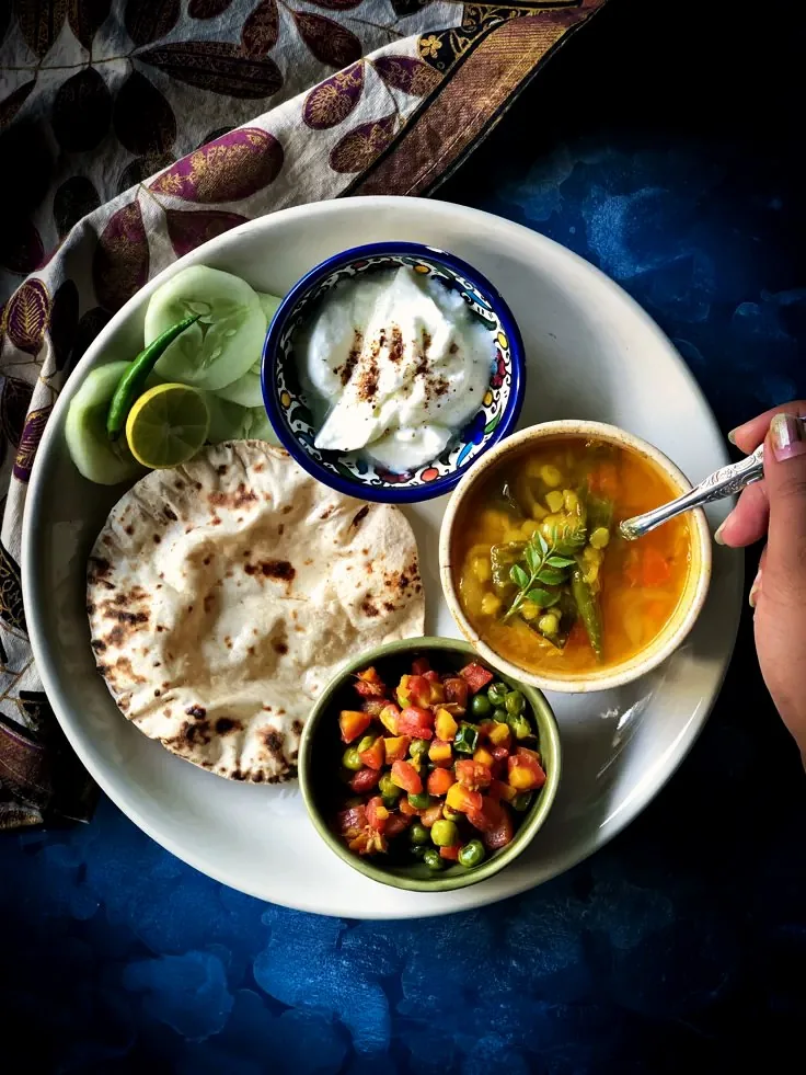 A home-cooked thali of dal, flatbread, yoghurt and vegetables