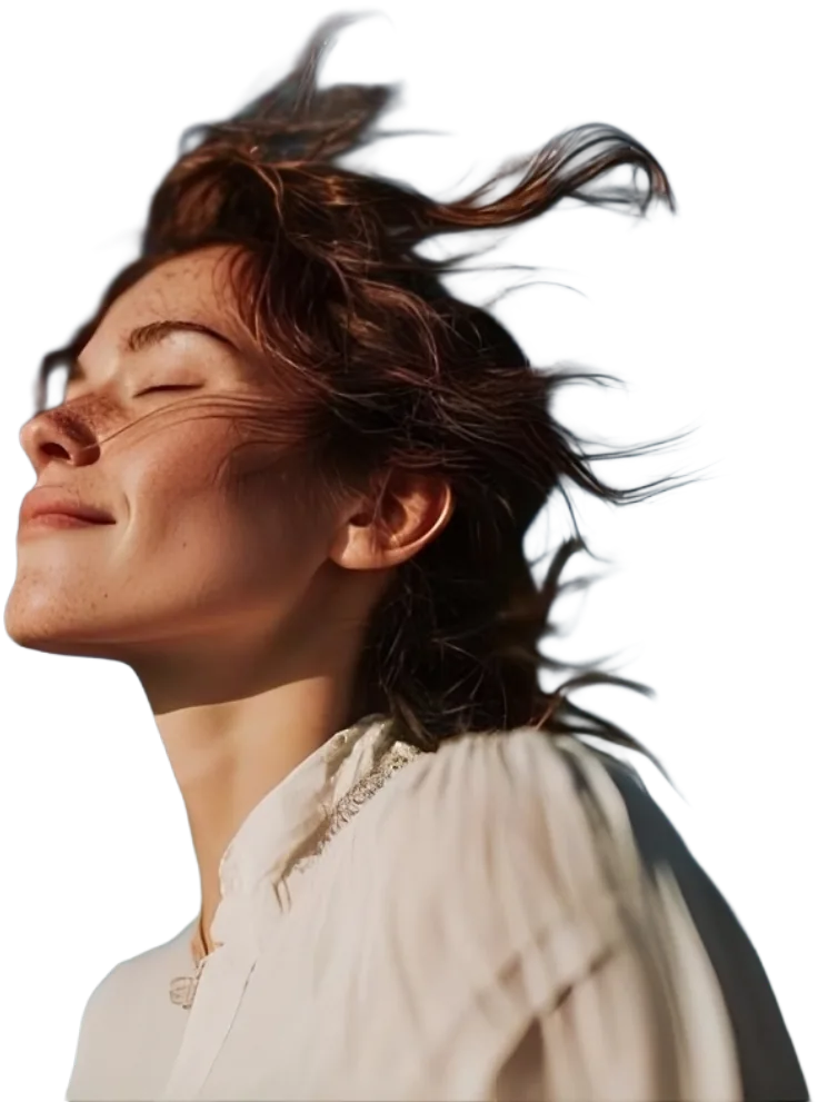 A woman with her eyes closed and her face turned up to the sun